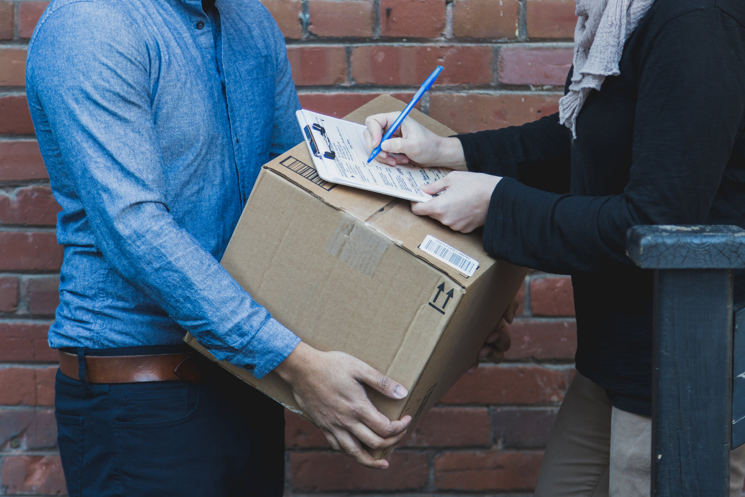 Man signing for delivered package